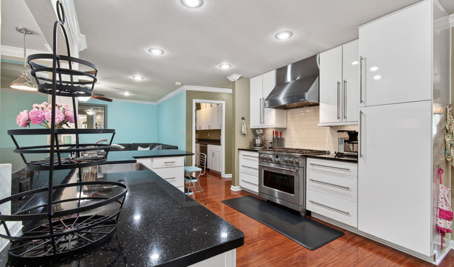 Modern kitchen with white cabinets and stainless steel appliances