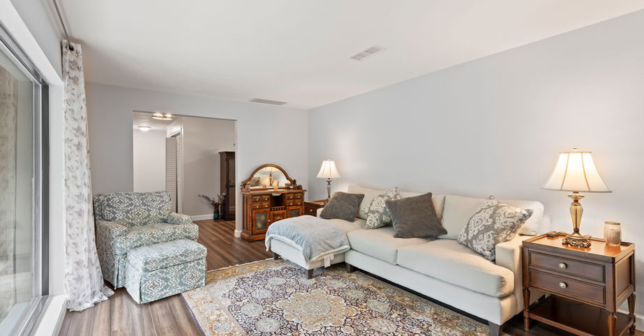 Cozy living room with sofa, chair, rug, and Kenwood $502,600 for sale.