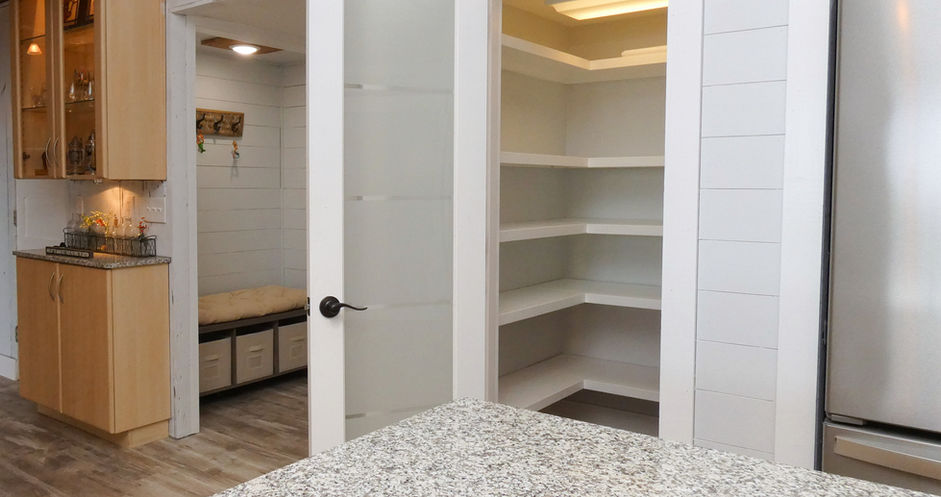 Open pantry with shelves and door, kitchen, bench with storage, granite countertop.
