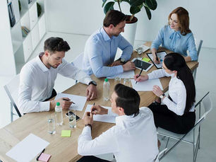 equipo de trabajo colaborando durante sesión de coaching de equipos en empresa