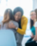 A woman hugging another woman
