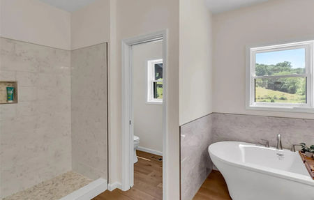 View of a walk-in tiled shower and vanity area in the Brockton modular home design.