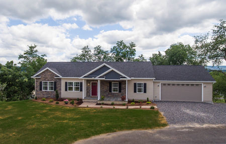 A wide view of the Easy Street custom modular homes pa model with professional landscaping.