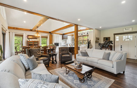 Custom Jacob's Creek modular home, living room, wood beams, fireplace, white sofas