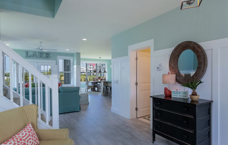 Hallway view showing white board and batten walls and neutral flooring.