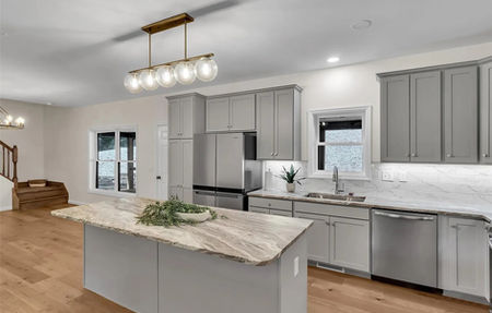 Wide view of the open kitchen and dining area in the Brockton custom modular homes pa model.