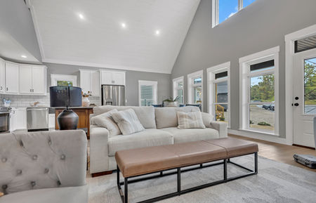 Copper Creek Cape modular home, living room, vaulted ceiling, tufted sofas
