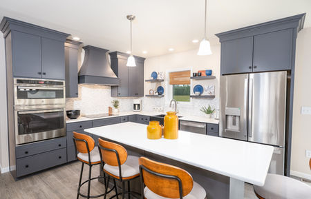 LeGrand two-story modular home, kitchen, gray cabinets, stainless appliances, dining table