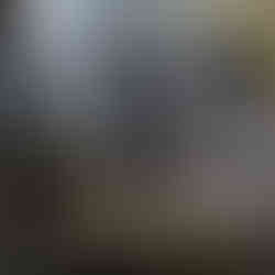 girl standing on rocks at base of waterfall