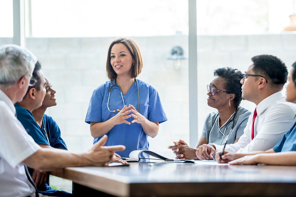 a nurse talking confidently to a group of doctors