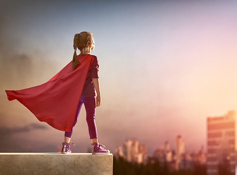 Little child girl plays superhero. Child on the background of sunset sky. Girl power concept.jpg