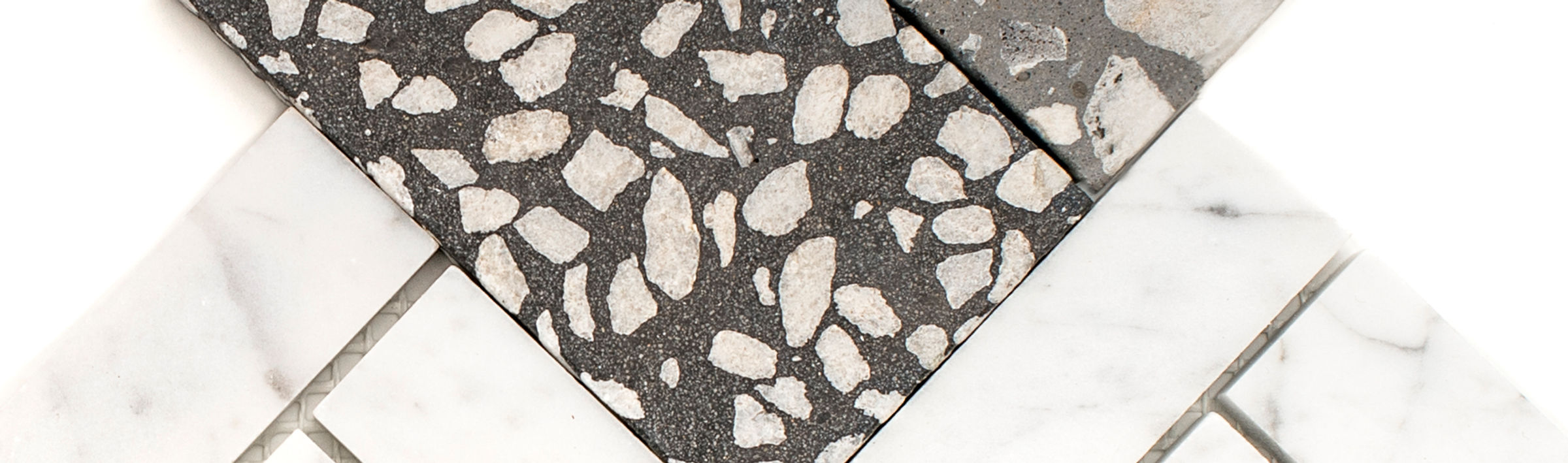 Two Pangaea terrazzo tiles of alternating shades of grey. On a white background.