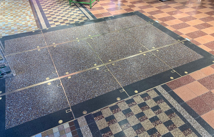 Abstract pattern. Red and pink marbled floors. Marbled square and black outline.