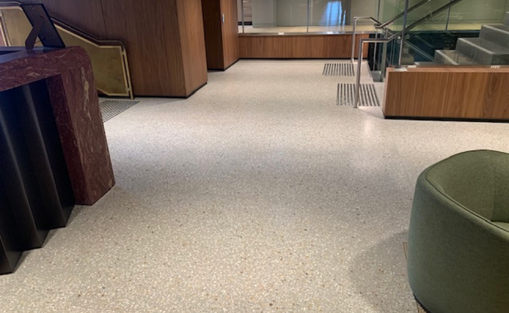 Modern lobby with terrazzo floor and wood stairs