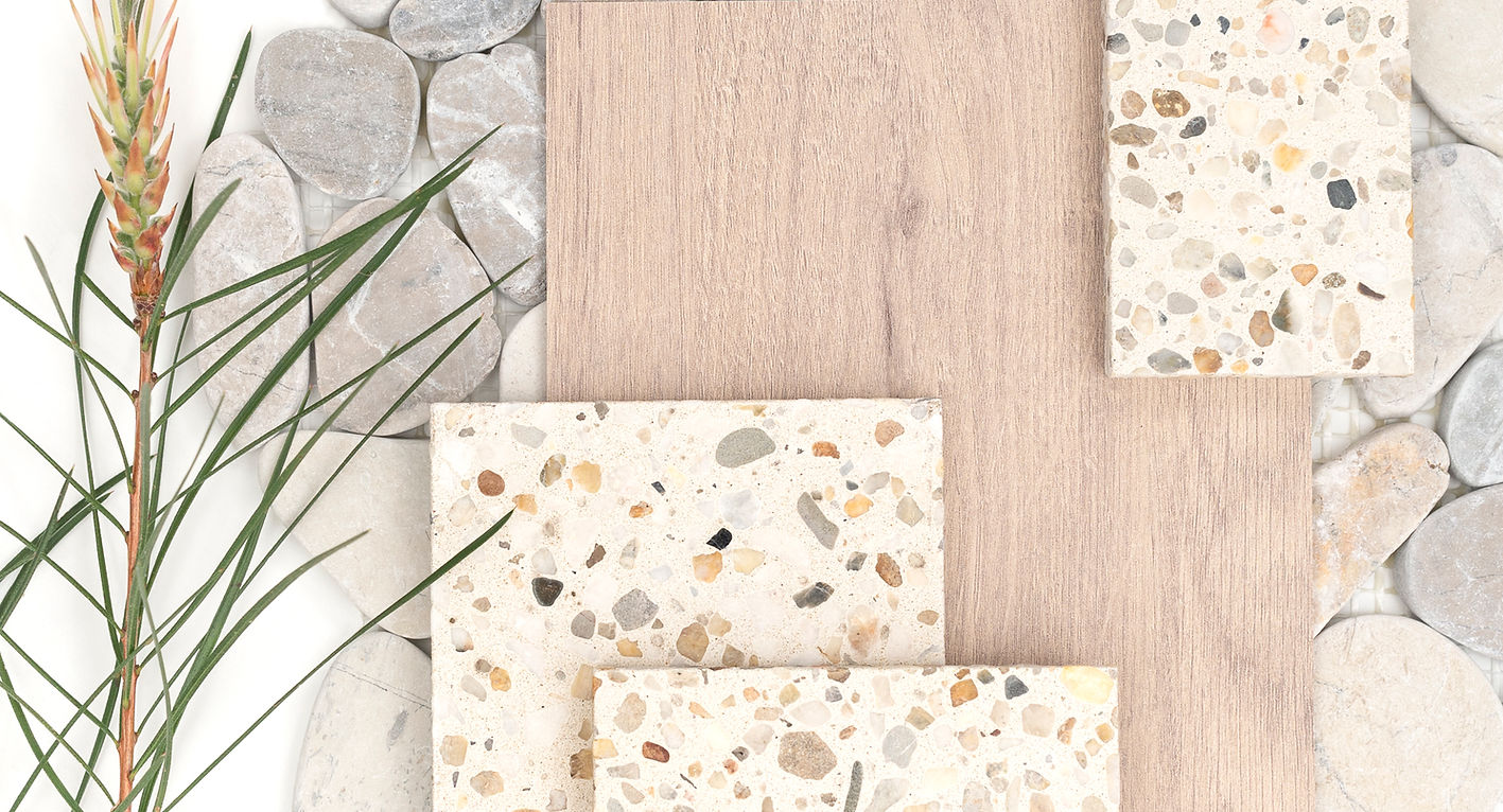 Variety of rock aggregate, white tile. Grey background, wooden slab and greenery.