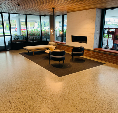 Exterior of commercial building; modern chairs, and carpet. Wide shot to reveal the welcoming interior.
