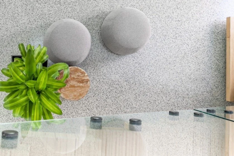 Pangaea marbled floor, with grey wall mounts, and a vibrant green plant.