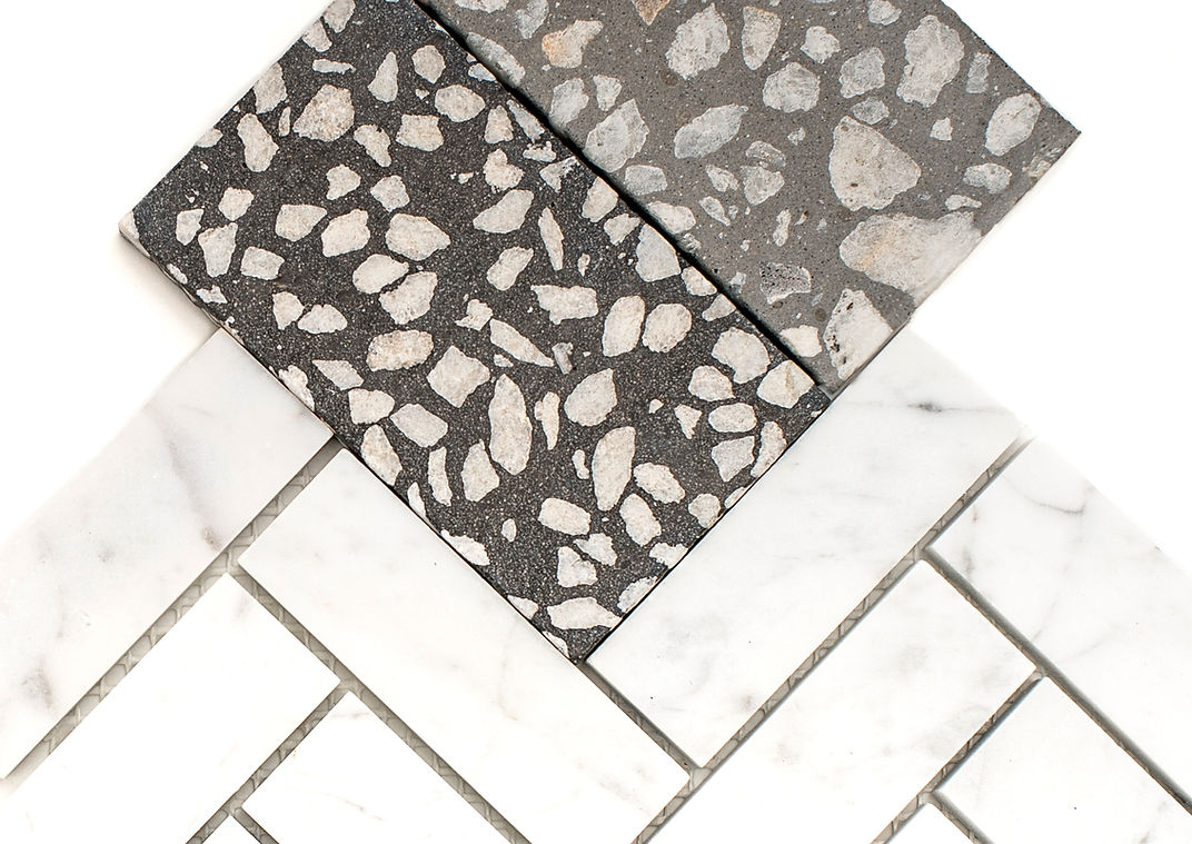 White tiles. Black and grey terrazzo style pieces.