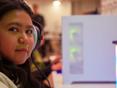 Game On Participant looking at the camera while playing a video game at the hub