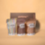 Gourmet popcorn gift box, consisting of a yellow and brown hamper box and three popcorn packets (rocky road, coffee, caramel)