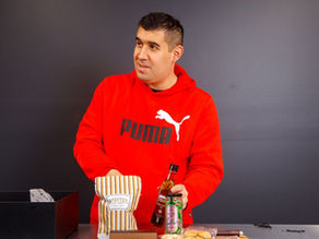 Idf of st george participant packing a Hamper Co Hamper with popcorn, lollies, and infused olive oil