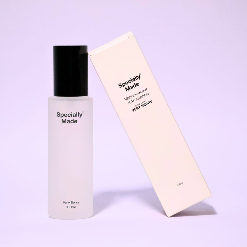 Very Berry Room Spray standing on a pink background with its white box leaning on it. The spray is in a frosted glass bottle