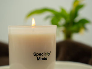 Lit Specially Made candle on a beach background with a palm tree