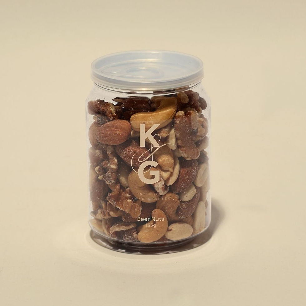 Jar of beer nuts, including peanuts, almonds, cashews, and walnuts. Olive green background