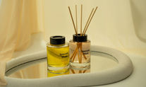 Specially made diffusers - they are in small, squat glass jars with black lids. One has reeds in it, the other is closed