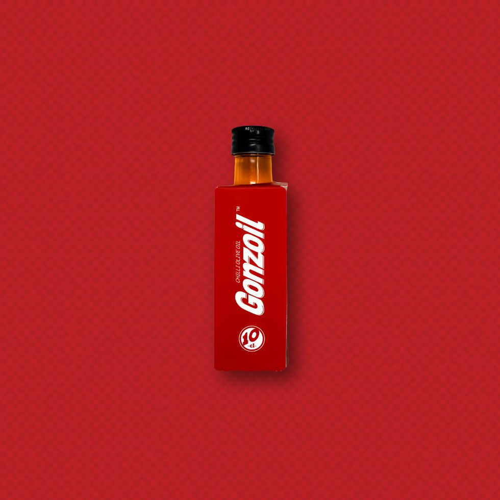 Chilli infused olive oil mini - glass bottle in a red cardboard wrap, red background.