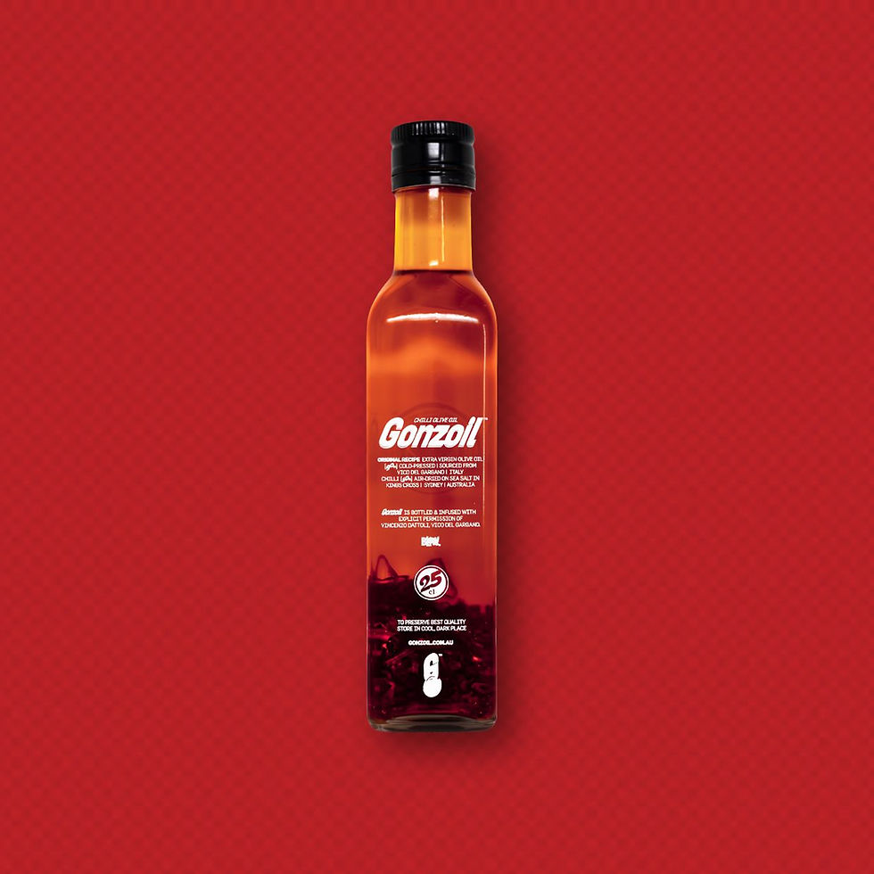 Gonzoil Chilli Infused Olive Oil in a glass bottle with white print and black cap, red background