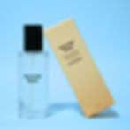 Mr Olympia Room Spray; a glass bottle with a black cap. The golden box leans against it. Both are on a sky-blue background.