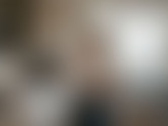 Homeowner spraying kitchen cabinets with HVLP sprayer