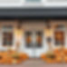 a beautiful modern restaurant front with whitewash brick color and double doors styled wit
