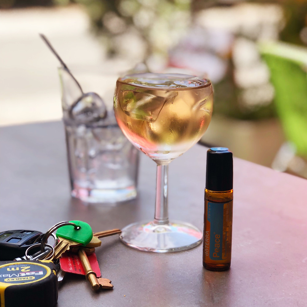 Glass of wine, keys and an essential oil