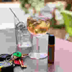 Glass of wine, keys and an essential oil