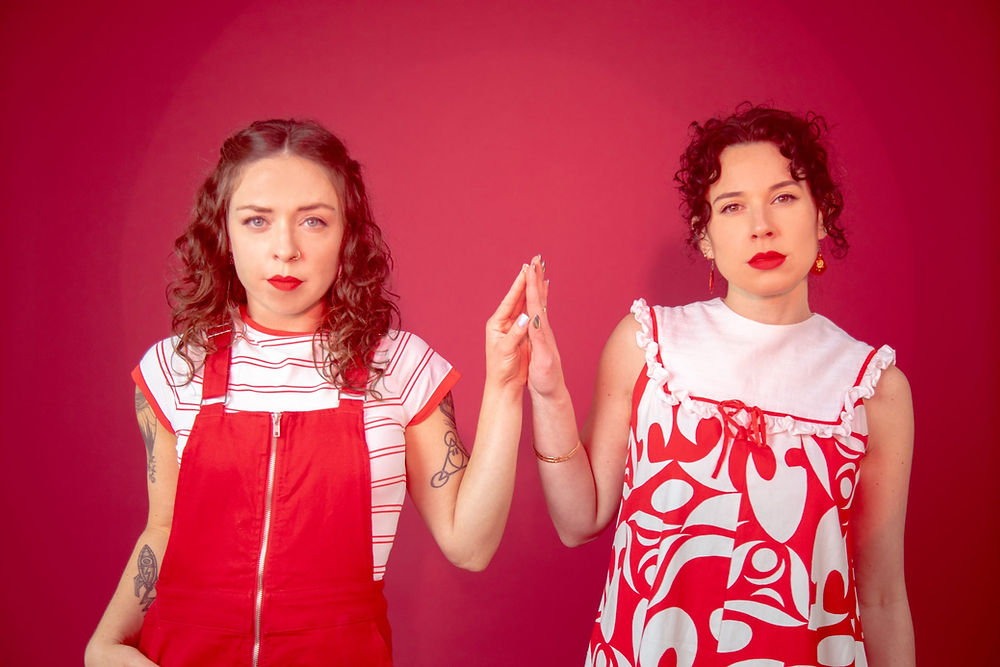 The Pussywillows in red and white outfits, hand in hand