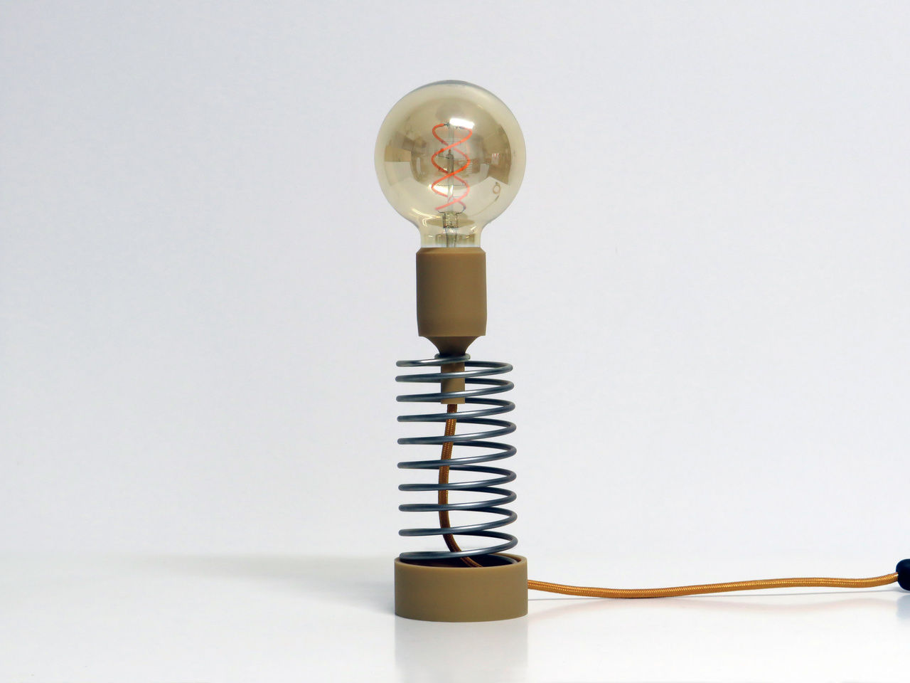 Zotropo lamp with a spiral shape and coffee components and bulb.
