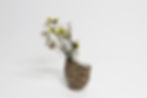 Brown Marmorite vase by HUGI.R — handmade textured ceramic piece holding yellow and white dried flowers.