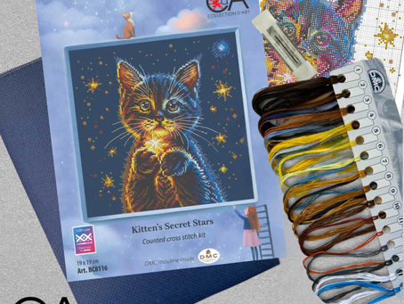 A cat holding the star cross stitch kit