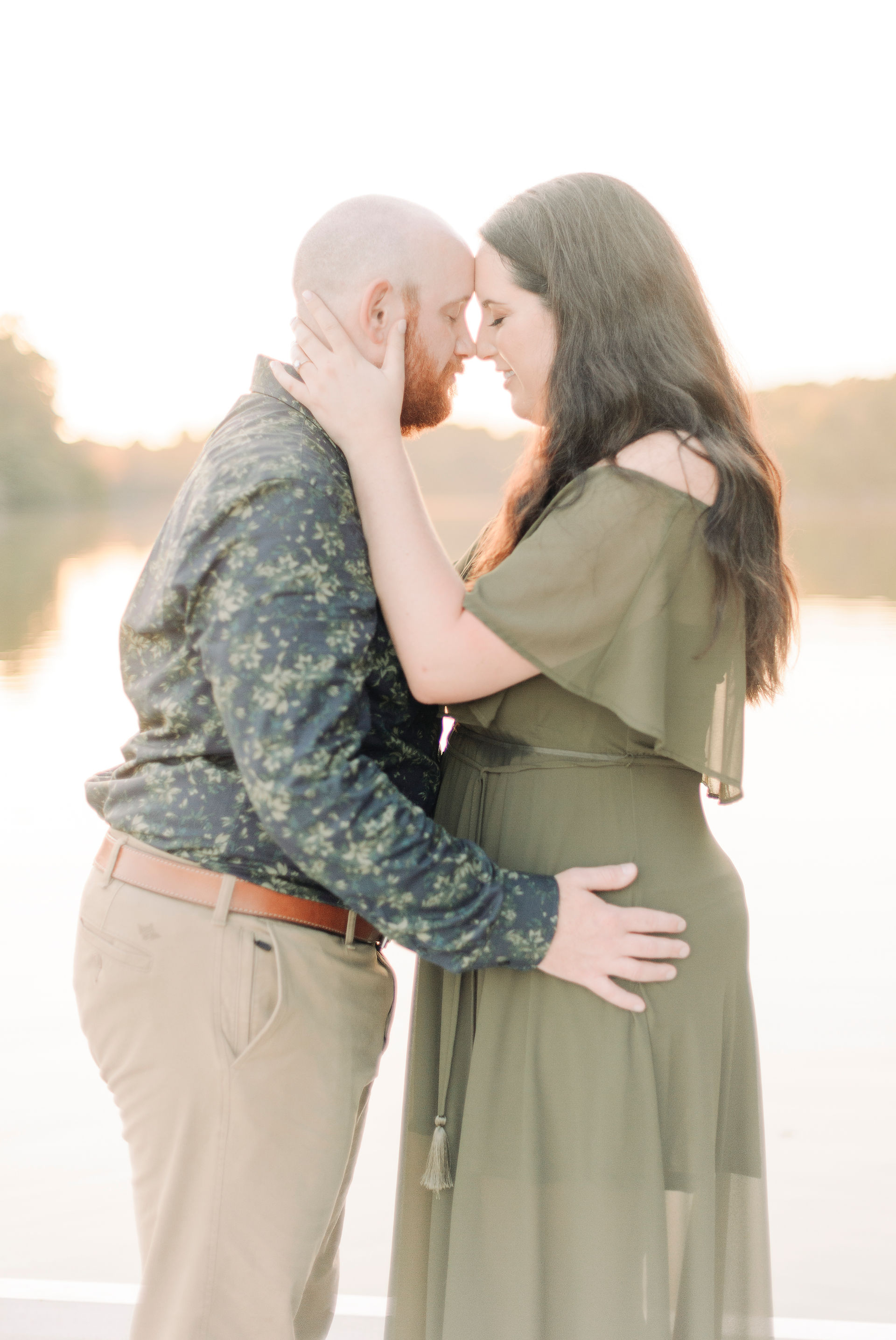 Sunset engagement session on a pier with couple kissing at Lumbs pond state park in Bear, Delaware. Photo by Jenifer Santo Photography