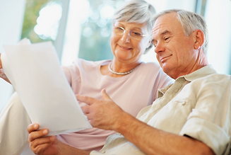Retired Couple Happily Reviewing Financial Information
