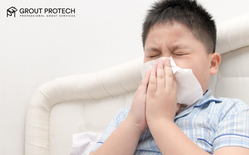child sneezing into a tissue.