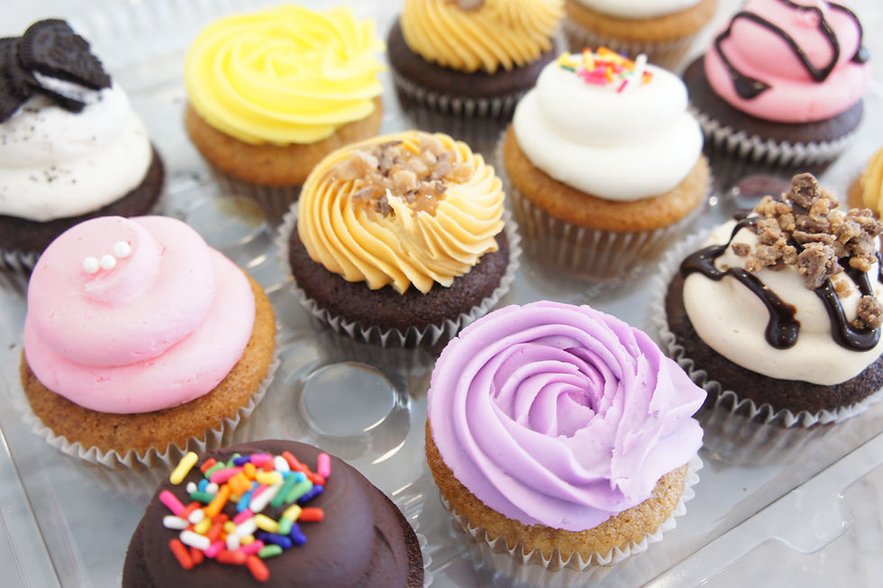 A mixed selection and variety of a dozen cupcakes bought from our bakery.