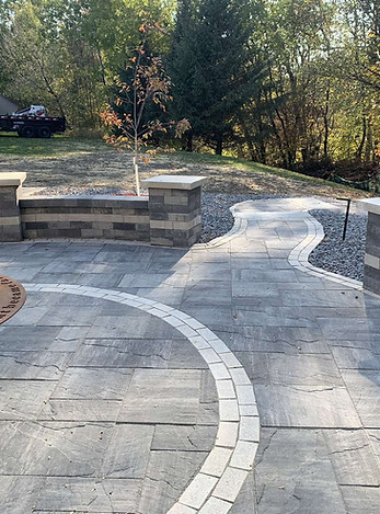 Installation of a paver patio, gas fire feature, and hardscaped seating walls and collumns.