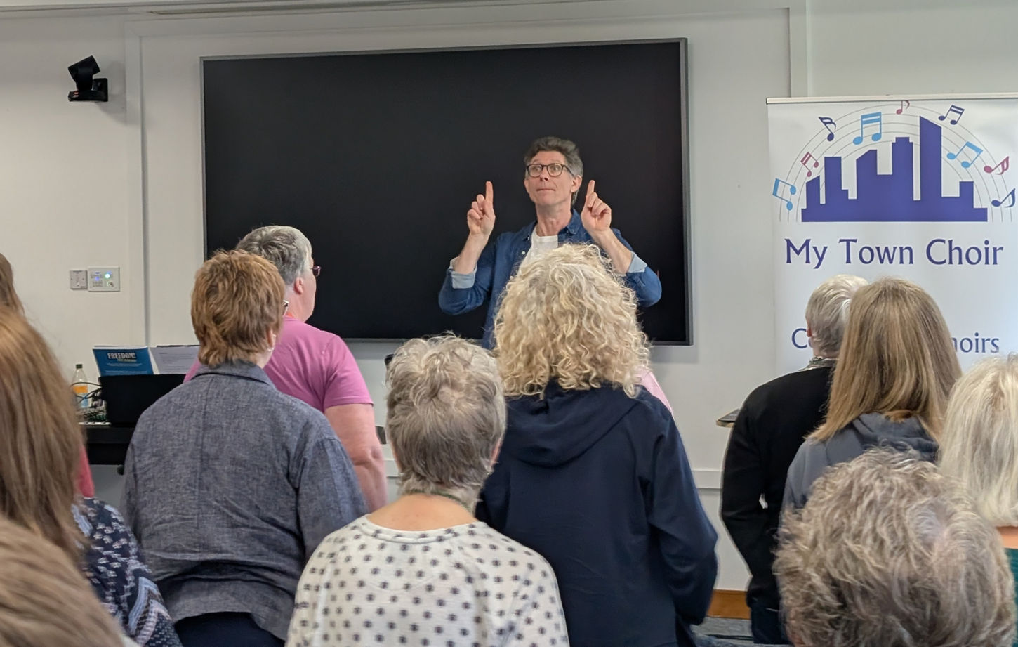 Alexander L'Strange leads us in song.