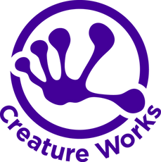 Creature Works logo. An extended hand that almost looks like it could belong to a lizard is visible in the middle.