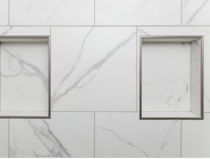 White marble wall with gray veining, featuring two recessed shelves. The sleek, clean design gives a modern and minimalistic feel.
