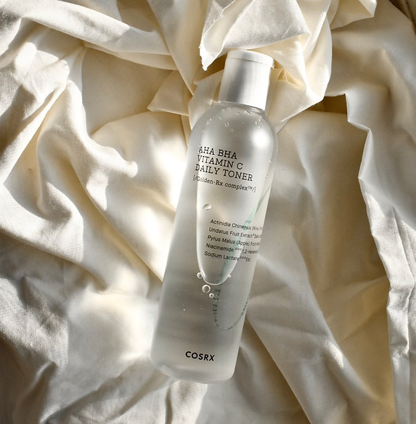 COSRX AHA BHA Daily Toner - COSRX AHA BHA Vitamin C Daily Toner bottle placed on soft white fabric, perfect for gentle exfoli