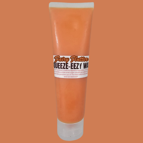 a tube of orange colour squeezy wax called fairy flutter on a orange background